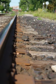 Shot low, following railroad tracks as they lead out of the frame.