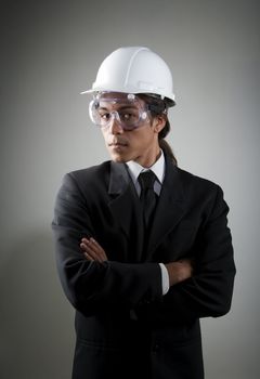 Handsome young mixed race man in hard hat and safety goggles