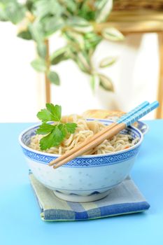 Bowl of oriental style noodles with wooden chopsticks.