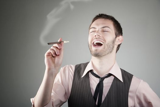 Portrait of laughing young Caucasian man with small cigar