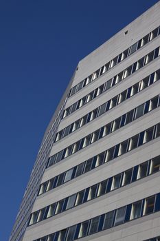 Modern office building on blue sky background