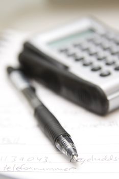 pen, calculator and agenda (selective focus)