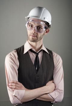 Handsome young man in hard hat and safety goggles