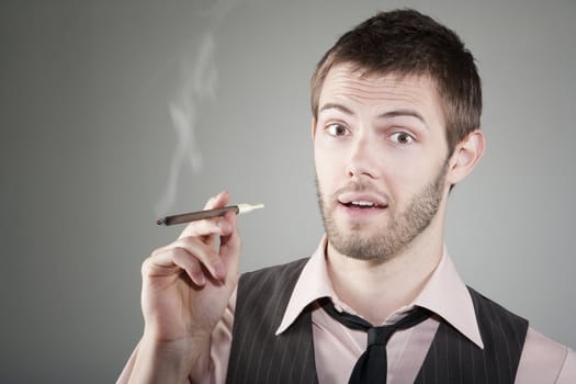 Portrait of happy young Caucasian man with small cigar