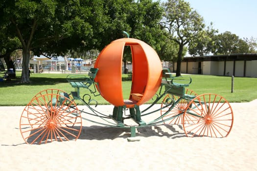 Elegant pumpkin carriage located in a park