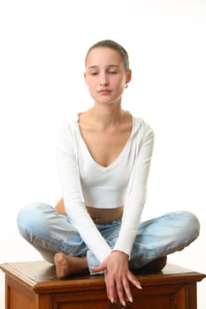 The beautiful girl sitting in a pose of a lotus