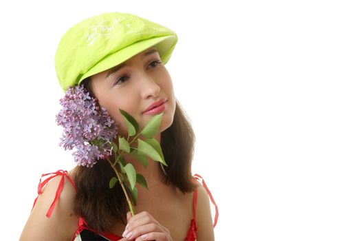 The girl in a green cap with a lilac bouquet