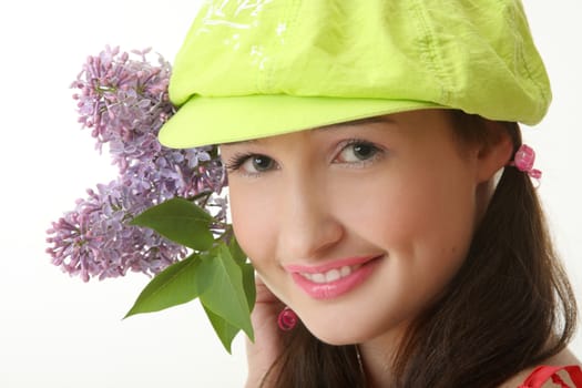 The girl in a green cap with a lilac bouquet