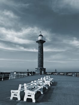 After the crowd have gone home for tea Whitby pier is left in peace revealing its quiet drama. This image has been converted to black and white then toned
