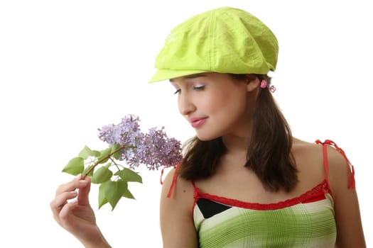 The girl in a green cap with a lilac bouquet