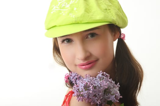 The girl in a green cap with a lilac bouquet