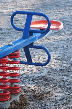 modern see-saw in a frosty childrens playground