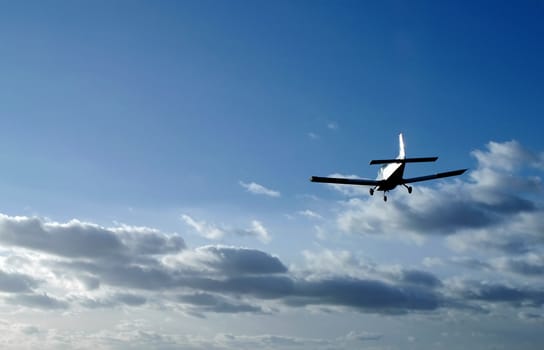 light aircraft on sunset landing approach