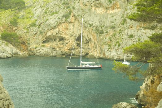 sailing boat in a lonley ocean bay in mallorca spain