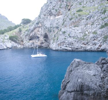 sailing boat in a lonley ocean bay in mallorca spain