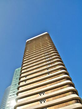 Golden skyscraper under blue sky hdr processed