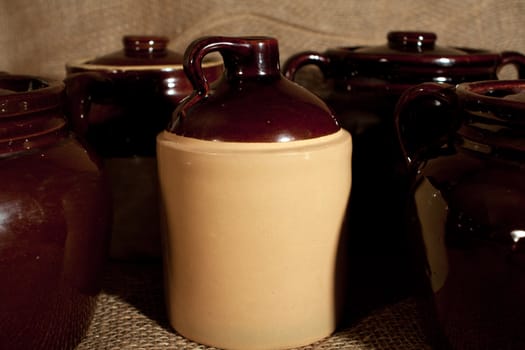 Some stoneware pottery on a burlap background