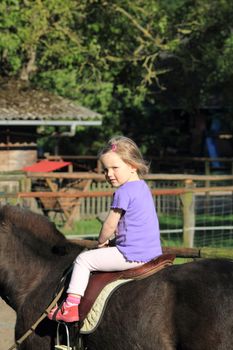 little girl on horseback