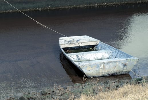 Old boat along the shore in very poor condition