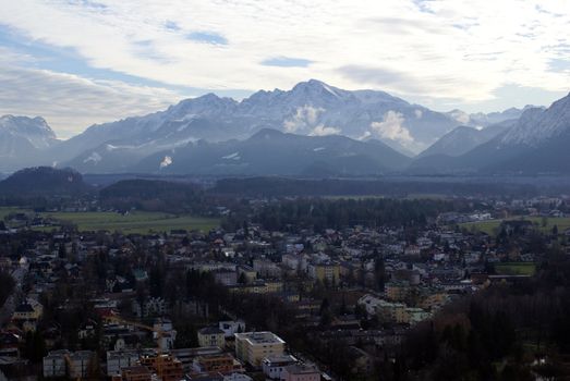 Aerial view of parts of Salzburg City with the Alps in the background.