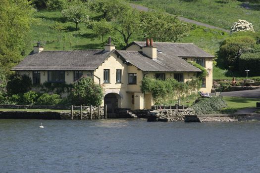 large white house built right next to the lake edge