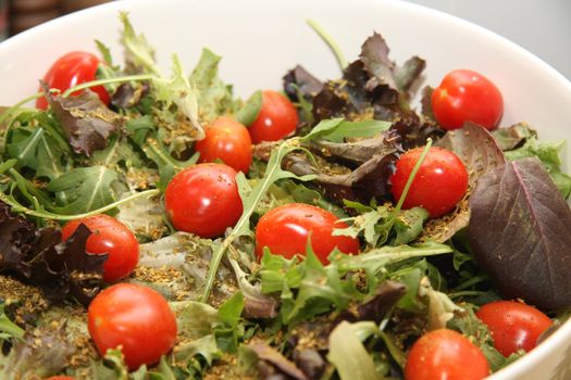 A fresh green salad with herbs and tomatoes