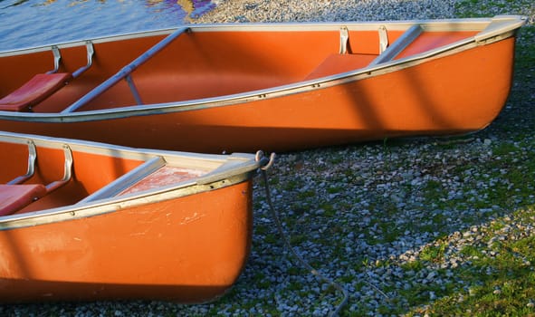 canoes on the river bank lit with the morning light