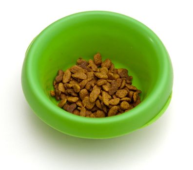 Green colored plastic pet bowl filled with brown cat food biscuits