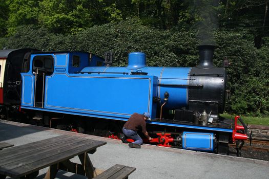 steam locomotive being checked by the driver