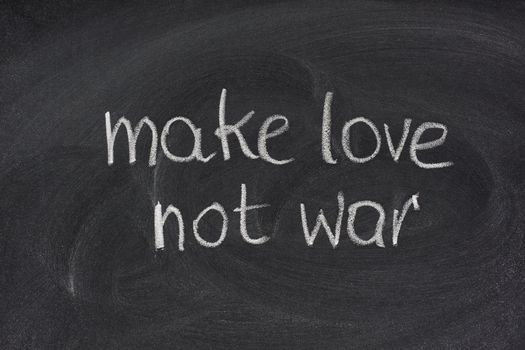 make love not war - anti-war slogan commonly associated with the American counterculture of the 1960sm white chalk handwriting on blackboard