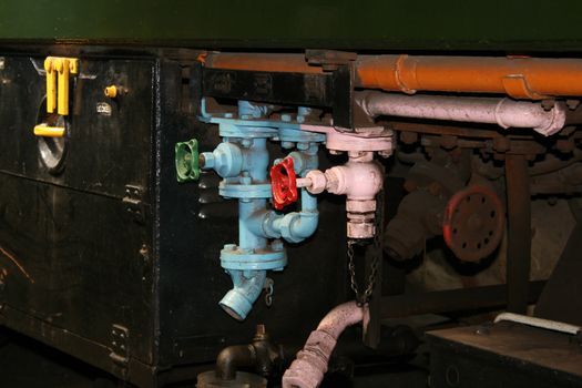 different coloured painted pipes on a steam train
