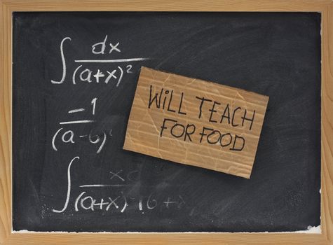 will teach for food - cardboard sign on blackboard with partially erased mathematical formulas