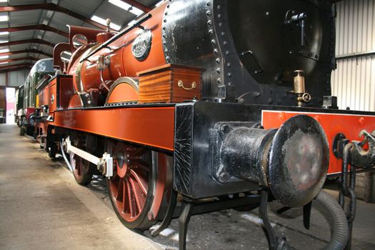 steam train in a train shed with a wooden box on board
