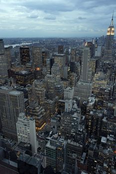 Photo of New York city as it's becomes nighttime. Empire State Building to the right.
