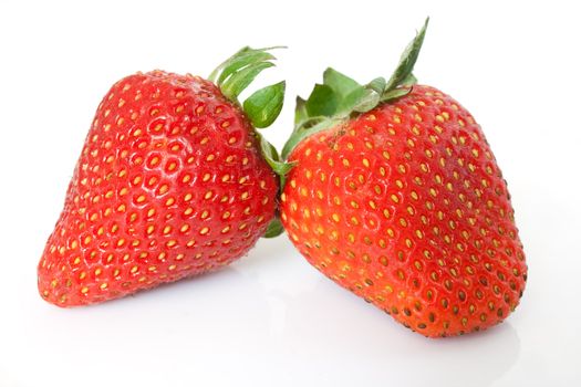 a couple of ripe strawberries isolated on white background