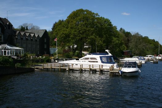 luxury yachts moored along the edge of lake windermere