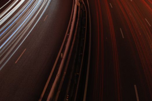 a night time shot of speeding traffic on a freeway