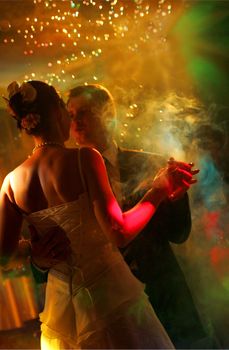 Newlywed couple dancing at their wedding reception.