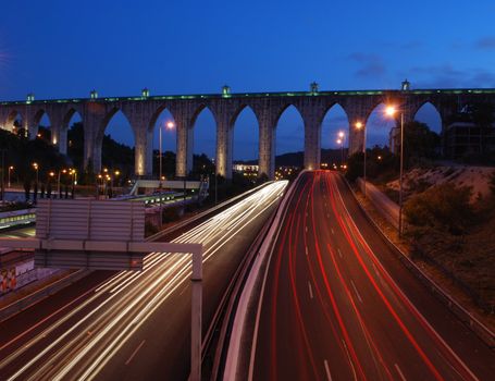 historic aqueduct in the city of Lisbon built in 18th century (car blur motion)