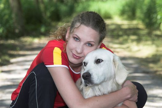 Beautiful woman on a summer day out with her dogs in the woods