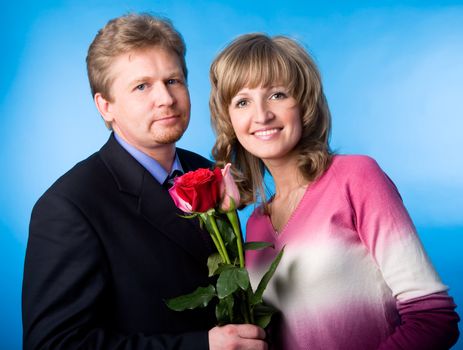 The man in a suit has presented the bouquet of flowers