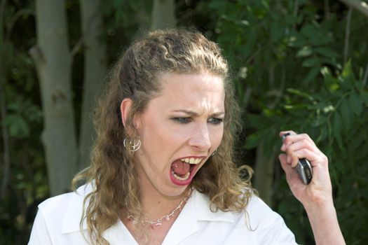 Beautiful businesswoman screaming in rage