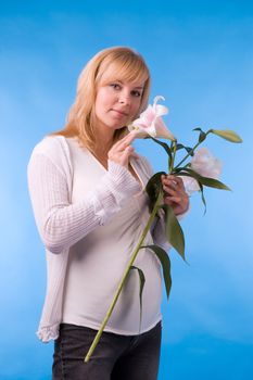 The fine pregnant woman with a bouquet of flowers in hands