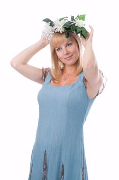 The attractive pregnant woman with a wreath of flowers