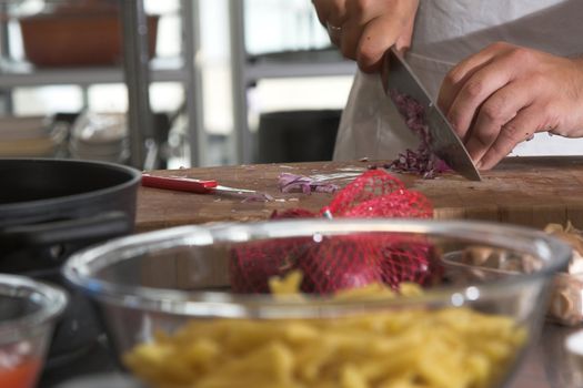 Chef preparing the onions for the pasta sauce