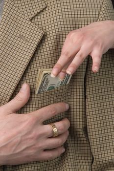 Money in a pocket of a checkered jacket