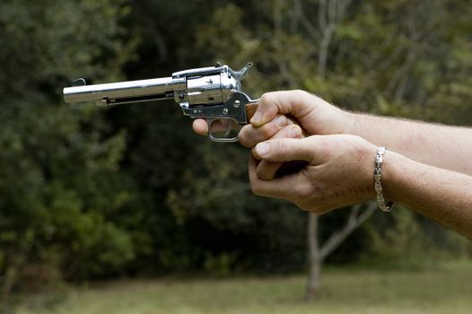 A man prepares to shoot his .22 pistol.