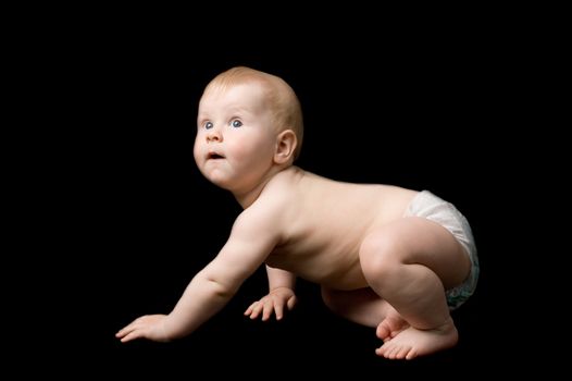 The small child in studio, on a black background