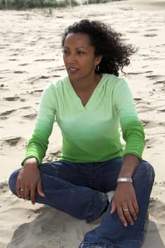 Beautiful black woman enjoying herself at the beach