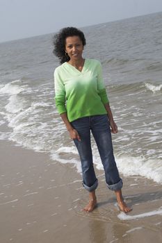 beautiful black woman standing by the waterside